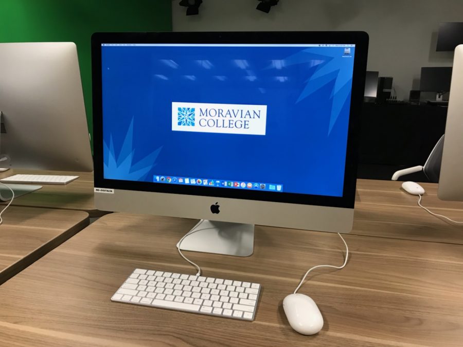 Photo of a Mac desktop computer screen with the Moravian College logo on the screen.