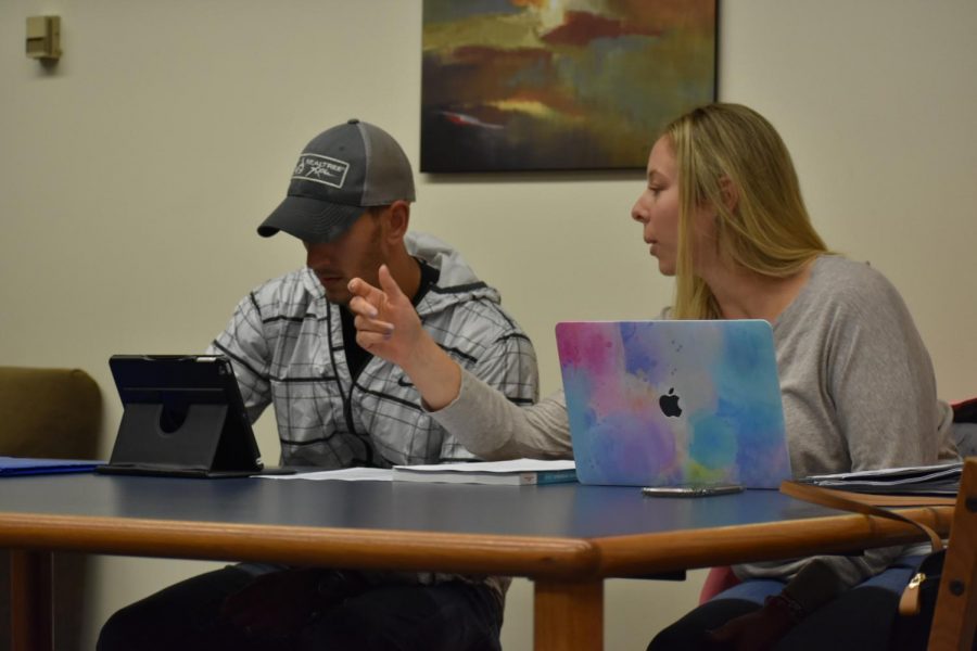 Kristina Szabo and John Pilla utilize their apple products to complete work in Reeves library. 
