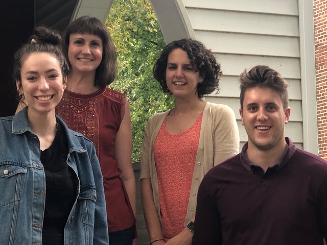 WAM Staff. Pictured (left to right) Gabrielle Stanley, Crystal Fodrey, Meg Mikovits, Christopher Hassay standing on the porch outside Zinzendorf Hall. 
