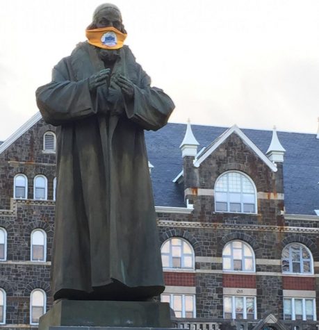 John Amos Comenius Statue sporting a mask to remind us to protect ourselves and others. Photo by: Mark Harris