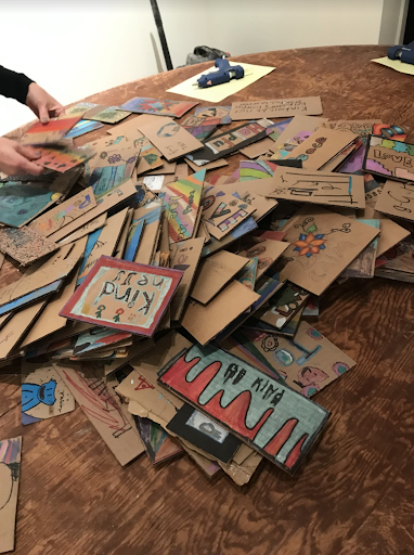 A behind the scenes look at organizing the artwork, sent in by Bethlehem Area School District students. These cardboard pieces would later be hung on the walls of Payne Gallery for the opening of "Loving Kindness" on Jan. 27