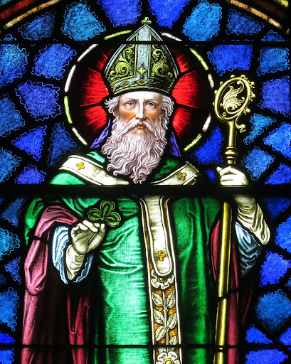 (A Stained Glass portrayal of Saint Patrick, depicted as a bishop, holding a Shamrock, from Wikimedia Commons, photo by Nheyob - Own work, CC BY-SA 4.0, https://commons.wikimedia.org/w/index.php?curid=39732088)