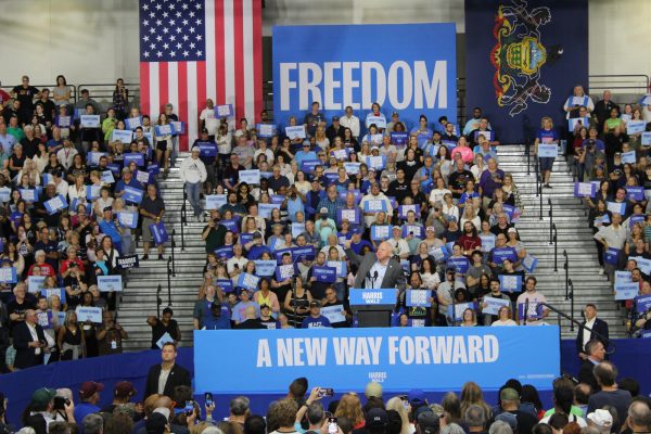 Photo by Lola Offenback. Tim Walz addressing crowd at rally. 