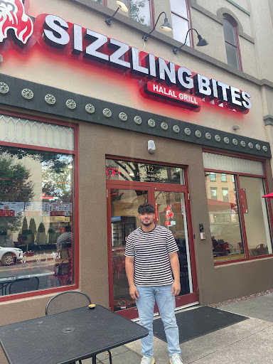 Photo by Talia Collina. Sizzling Bites owner Abdul Awali, age 19, outside his restaurant. 
