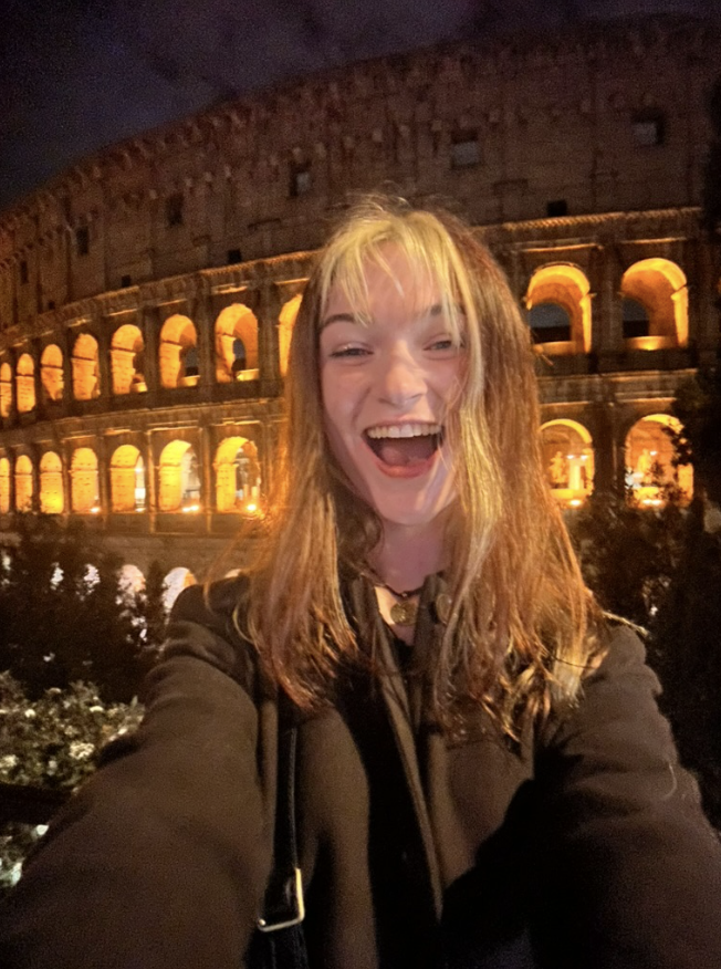 Pictured: Liz in front of the Colosseum in Rome. Photo by Liz Kameen.
