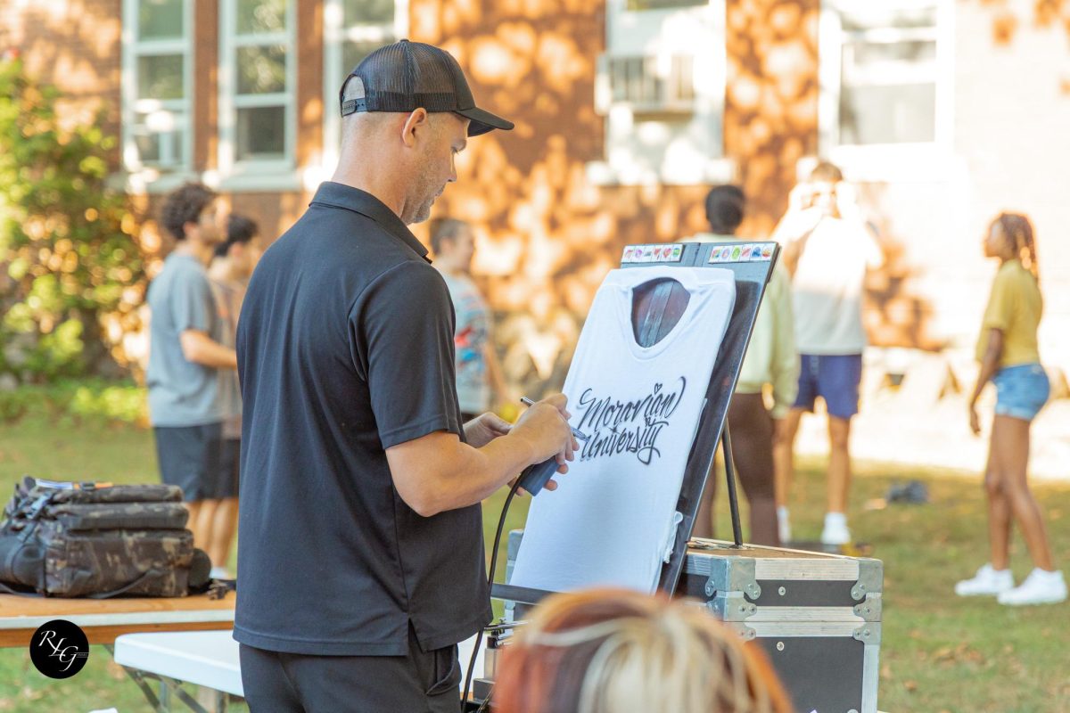 An airbrush artist designed shirts for students.